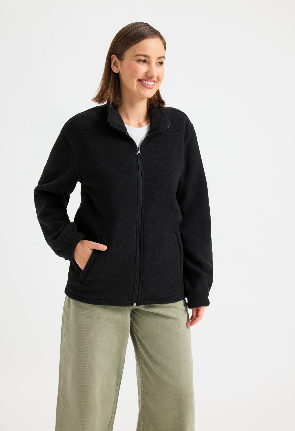Female model wearing a black Uneek fleece